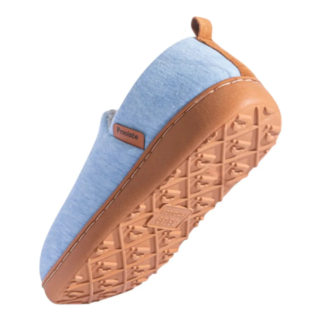 Overhead angled shot of a black slip-on slipper showing the brand label tab and cushioned collar