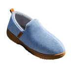Close-up side shot of a black slip-on slipper showing the ribbed fabric texture and tan contrast sole