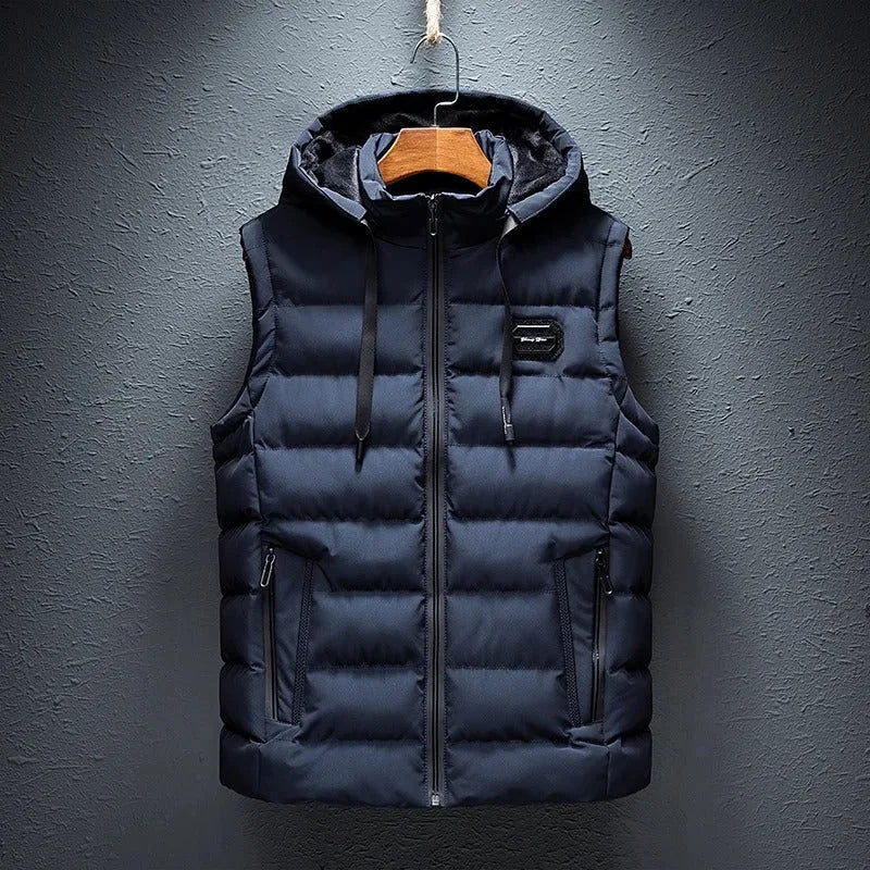 Dark navy padded gilet with fleece-lined hood, zip pockets and drawcord, shown hanging on a wooden hanger