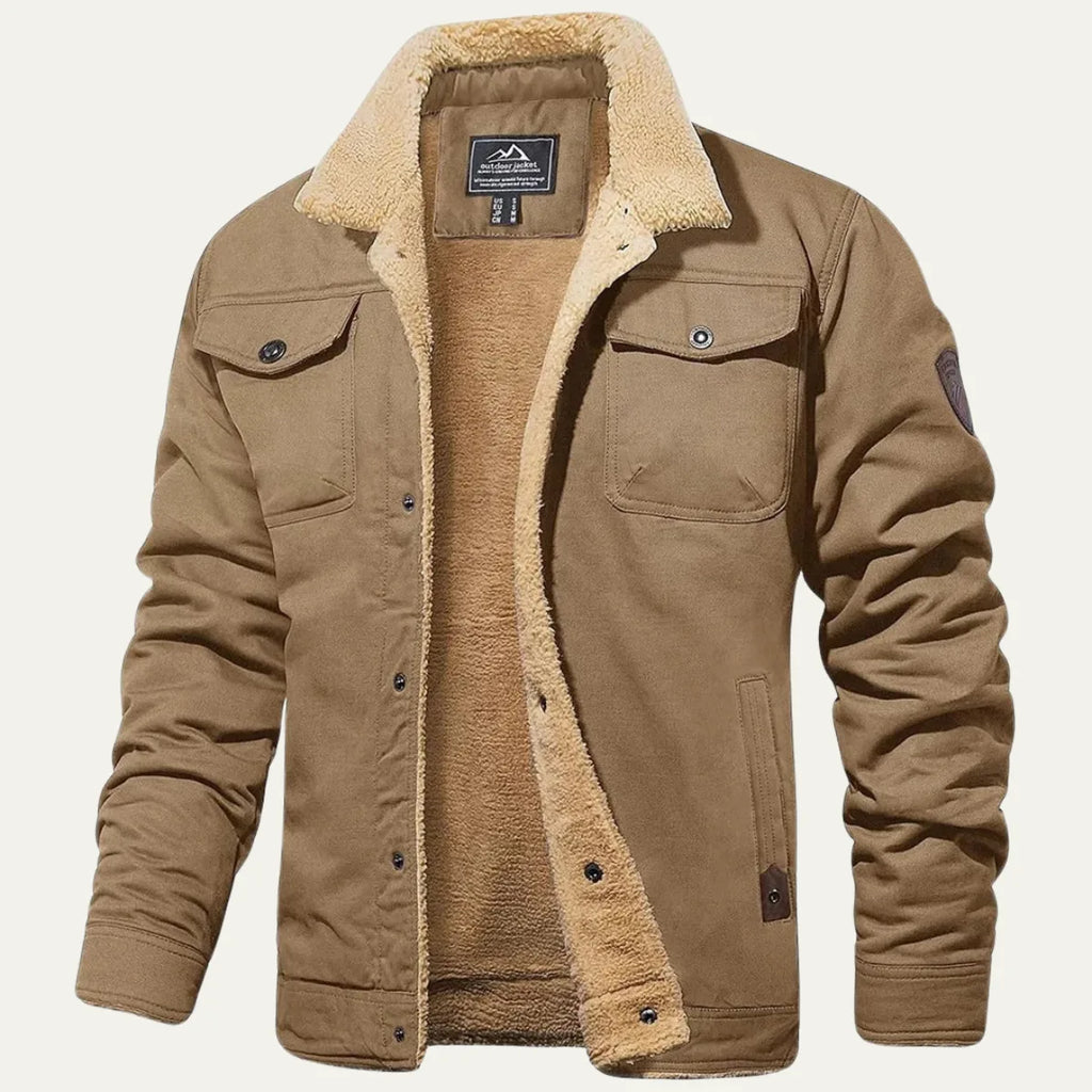 Front view of a khaki trucker-style jacket with sherpa collar, buttoned flap pockets and sleeve patch
