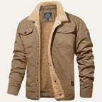Front view of a khaki trucker-style jacket with sherpa collar, buttoned flap pockets and sleeve patch