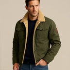 Man wearing the jacket with sherpa collar turned up, hand resting at the collar