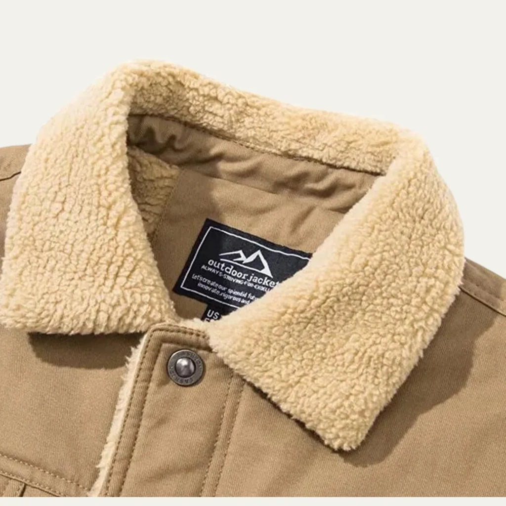 Close-up of the sherpa fleece collar and brand label stitched inside a khaki jacket