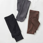Flat lay of folded fleece-lined tights in black, grey and brown showing the brushed inner lining