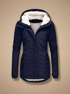 Navy hooded jacket with faux fur trim, unzipped front showing cream fleece lining and snap-buttoned collar