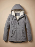 Grey hooded parka with drawstring hood and flap pockets, cream fleece lining showing at the hem