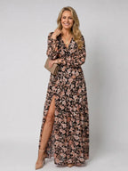 Black and pink floral maxi dress with long sleeves, ruffled neckline and a thigh-high side split