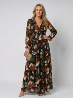 Black floral maxi dress with rust and cream blooms, ruffled trim and tiered skirt silhouette