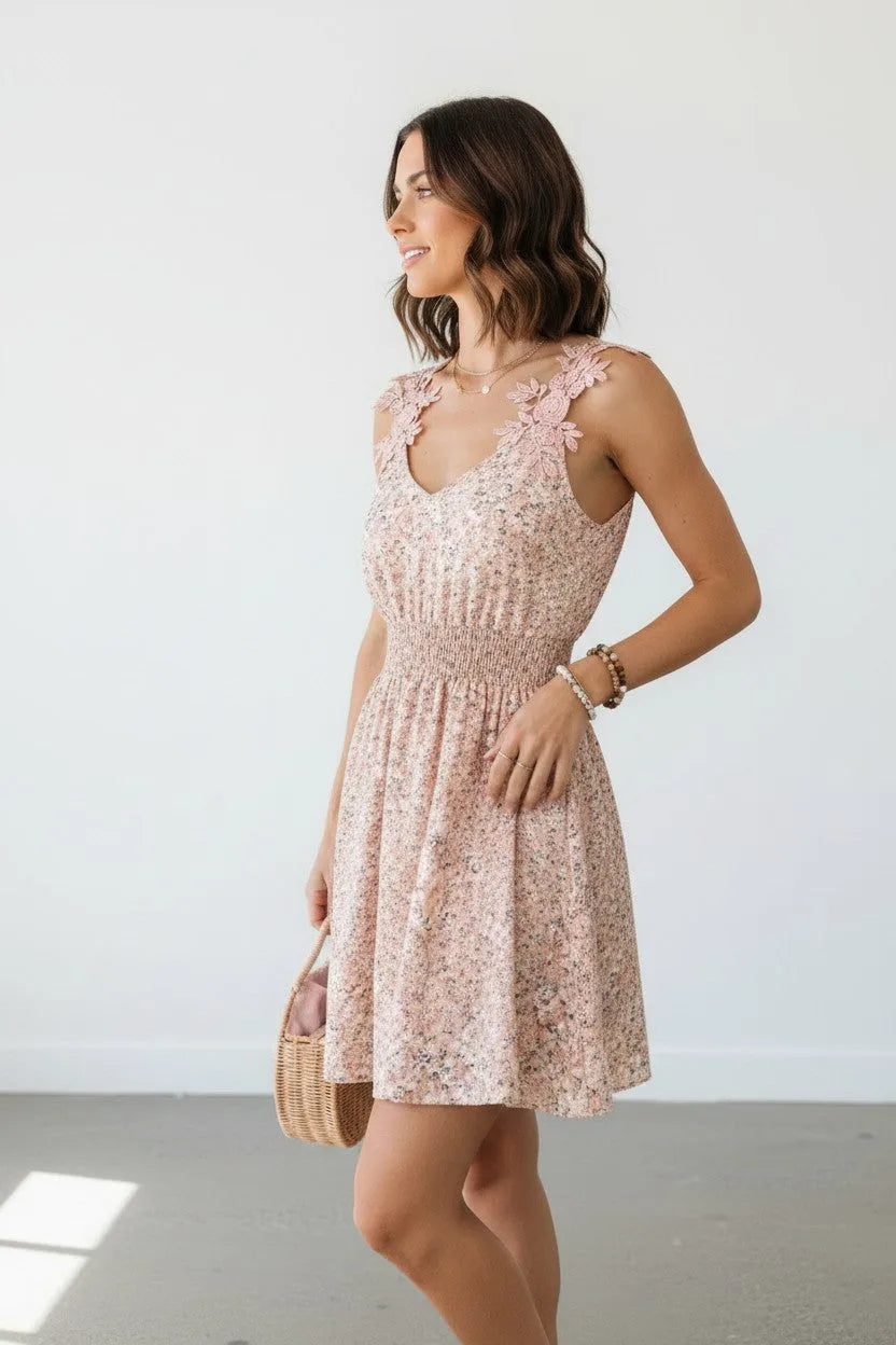 Side profile of the pink floral dress showing the shirred waist and A-line skirt, styled with a woven basket bag