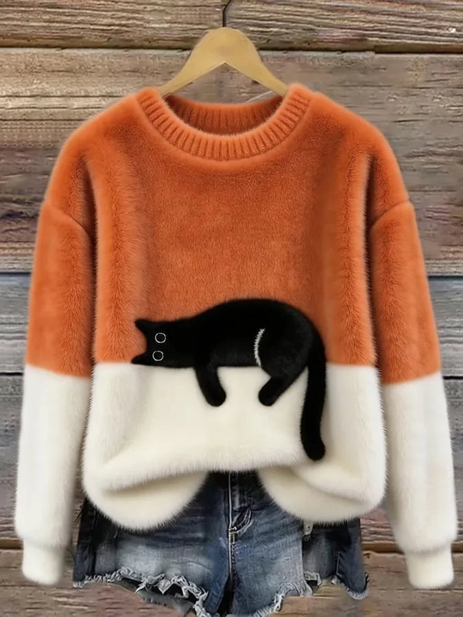 Orange and cream fluffy knit jumper featuring an embroidered black cat design across the hem