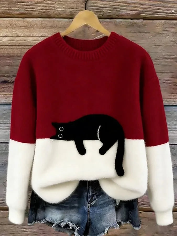 Burgundy red and white colour-block jumper with a black cat graphic detail near the waist