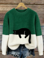 Green and cream two-tone fuzzy jumper with a black cat design placed at the colour-block line