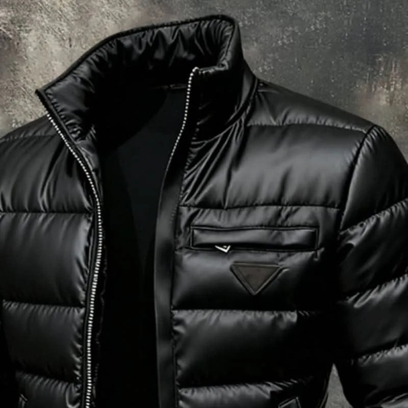 Close-up of the chest pocket with zip pulls and triangular logo tab on the shiny quilted puffer jacket
