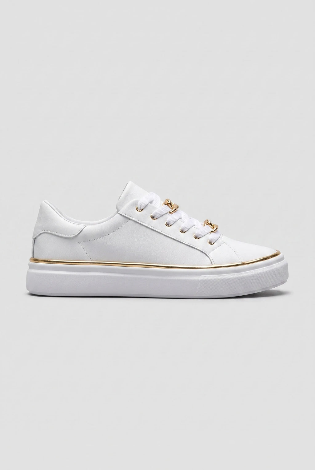 Side view of white trainer with gold chain-link lace detail and slim gold trim along the white flatform sole