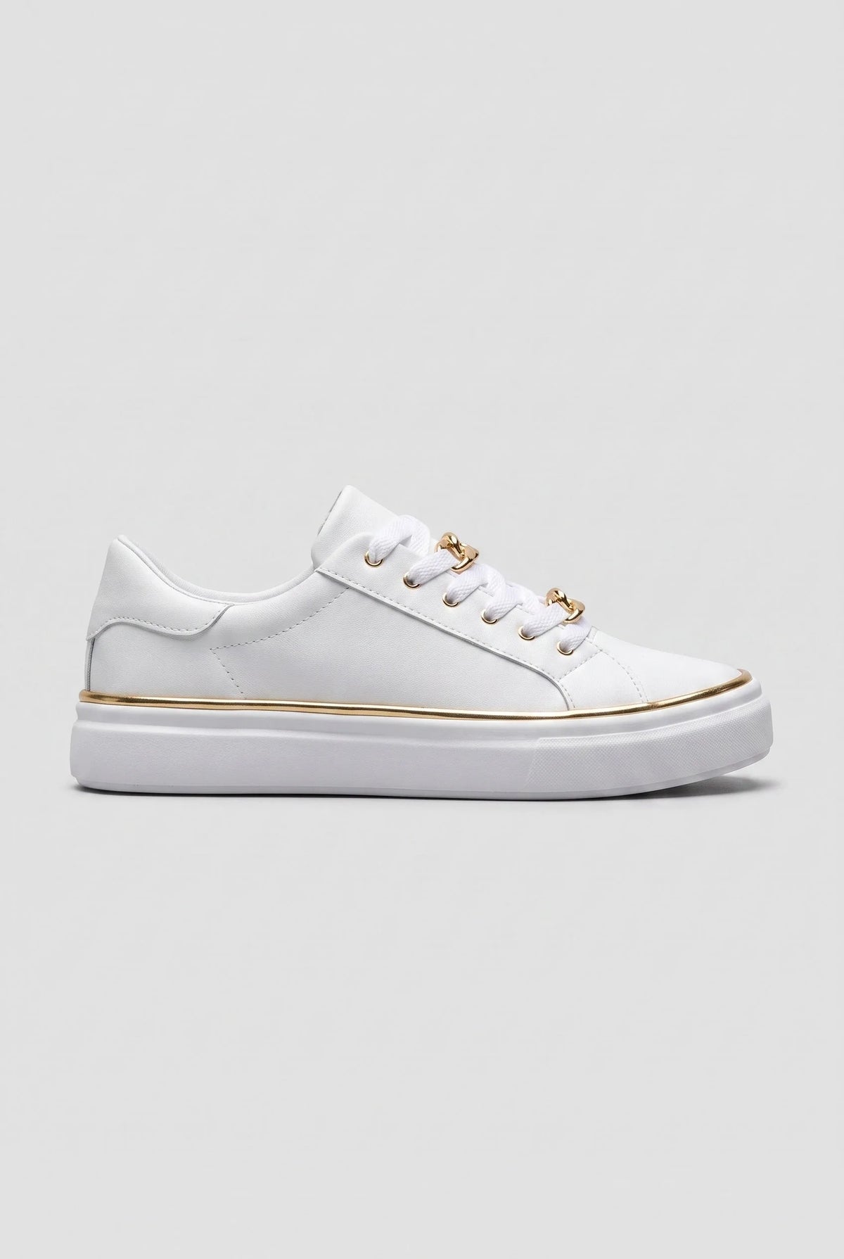 Side view of white trainer with gold chain-link lace detail and slim gold trim along the white flatform sole