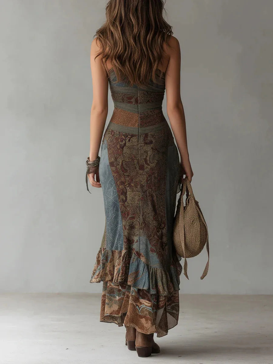 Back view of the asymmetric maxi dress showing the fitted waist seam, ruffled tiered skirt and floor-sweeping length.