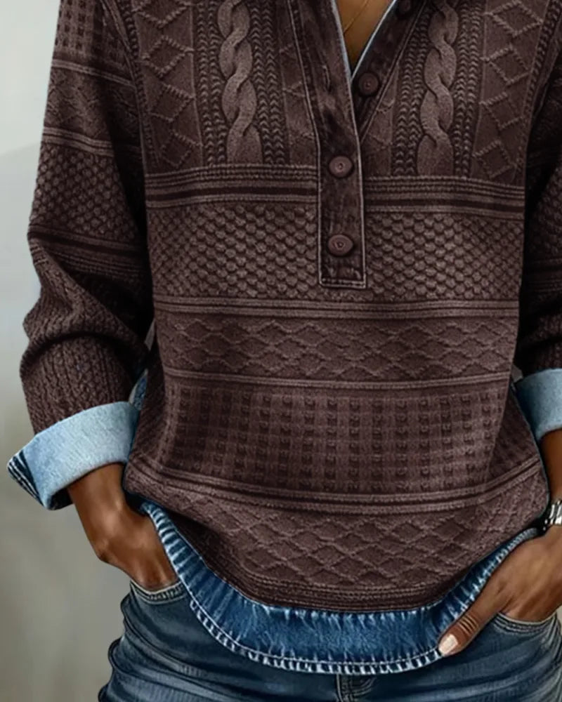 Detail shot of coffee brown cable and honeycomb knit texture with buttoned placket and rolled denim-style cuff
