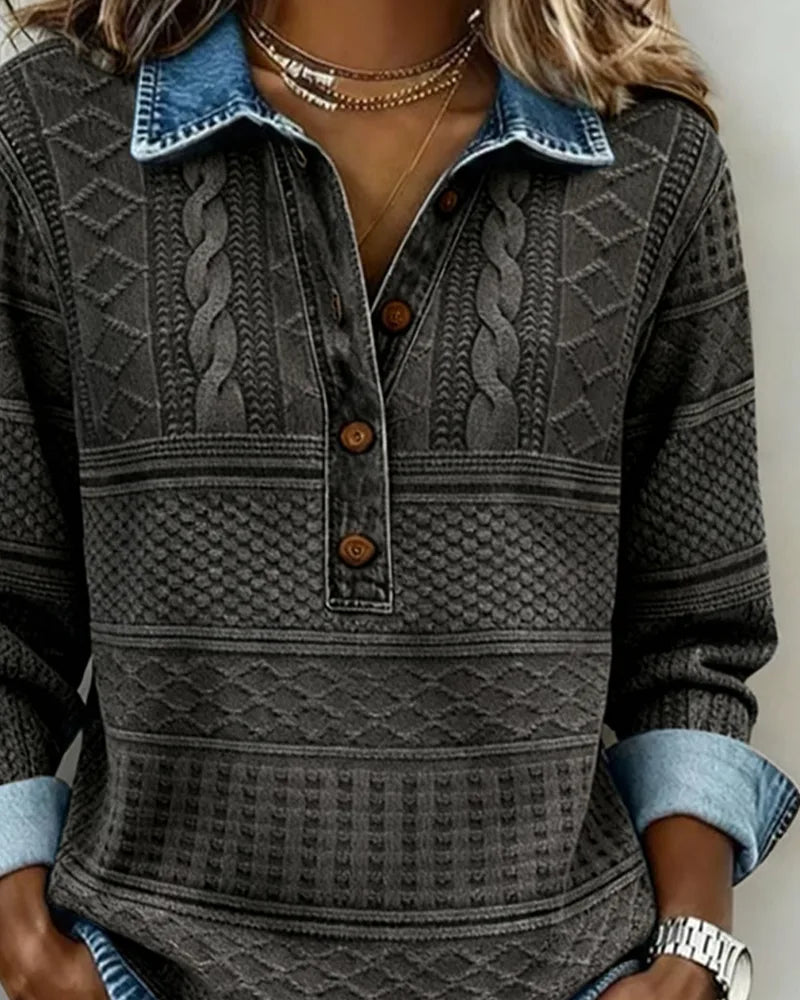 Close-up of charcoal grey knit jumper with denim-style collar, cable knit panel and brown button placket