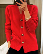 Red V-neck cardigan with gold heart buttons down the front, shown with ribbed sleeve cuffs