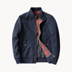 Navy blue Harrington jacket laid flat, fully unzipped, showing red tartan lining and stand collar