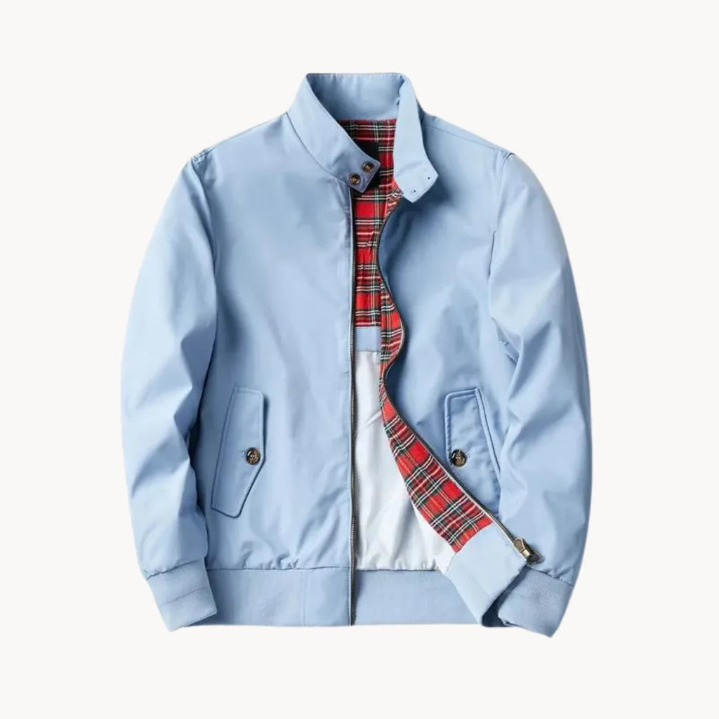Front flat lay of navy blue jacket showing flap pockets, ribbed hem and tartan-lined interior