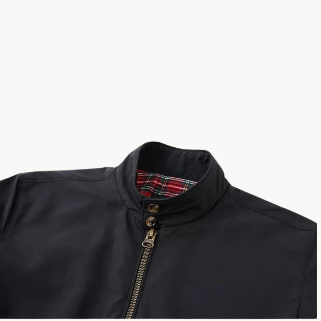 Close-up of black jacket collar and double-button neck fastening with tartan trim visible inside