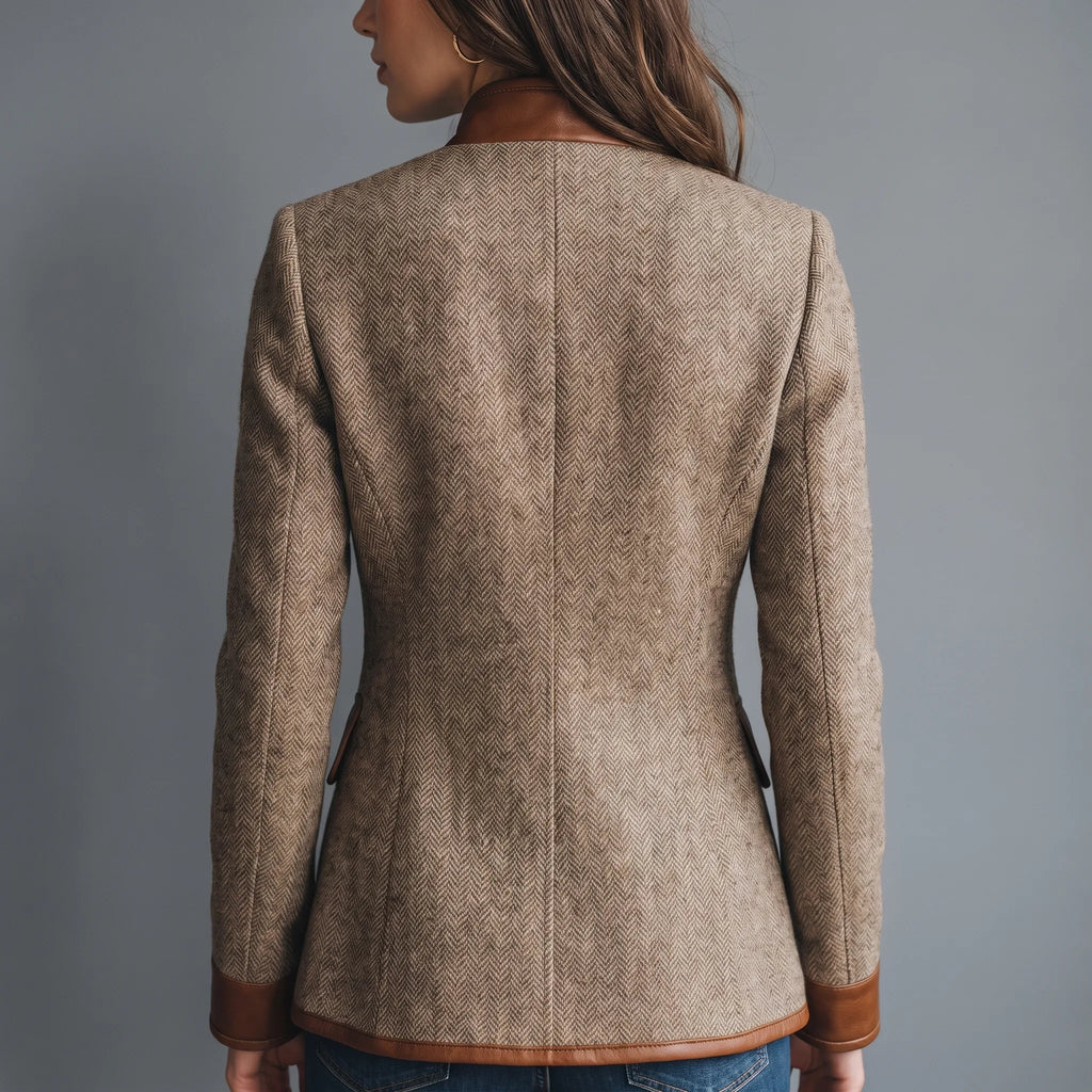 Back view of the tailored tweed jacket, showing the fitted waist shaping and leather-trimmed cuffs