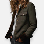 Side profile of the tailored jacket showing the flap chest pocket and velvet cuff trim
