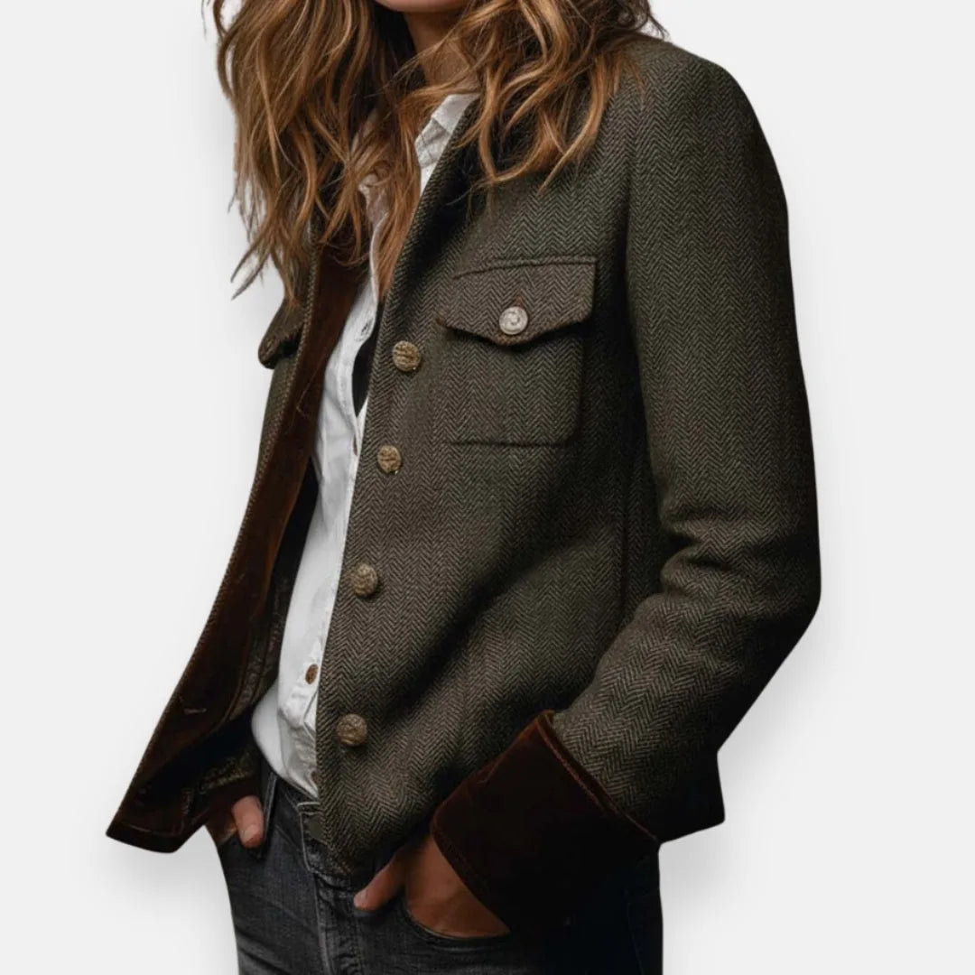 Side profile of the tailored jacket showing the flap chest pocket and velvet cuff trim