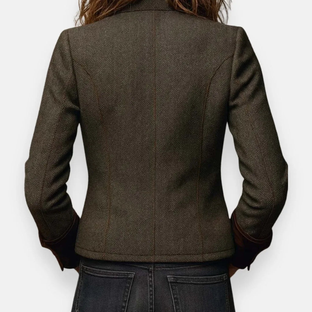 Back view of the jacket showing the fitted silhouette with princess seam tailoring