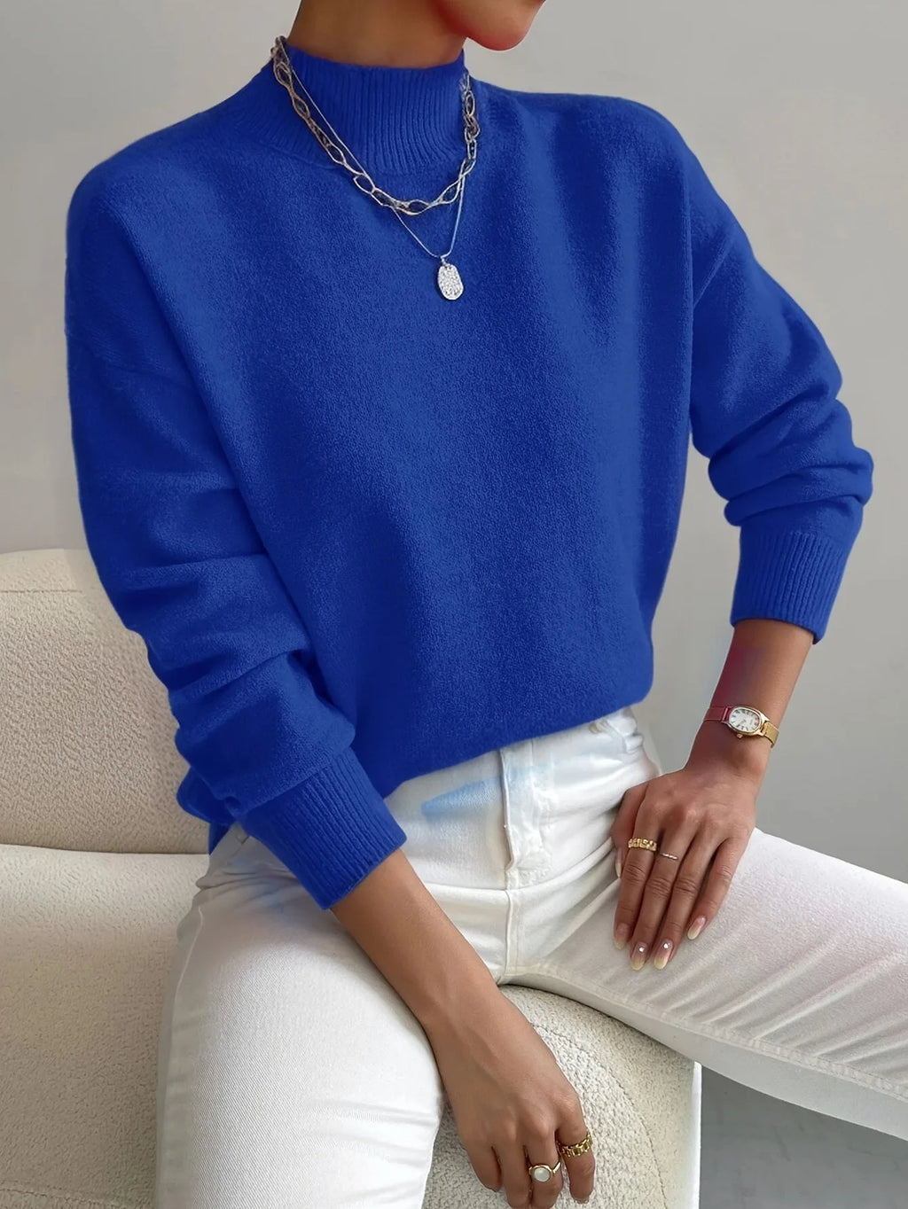 Close-up of ribbed mock neck collar and soft knit shoulder detail on a long sleeve jumper.