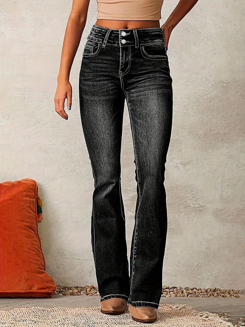 Front view of black washed denim flared jeans with high waist and double button fastening detail