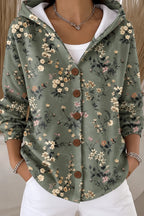 Sage green hooded cardigan-style jacket covered in a delicate wildflower and leaf print with brown buttons