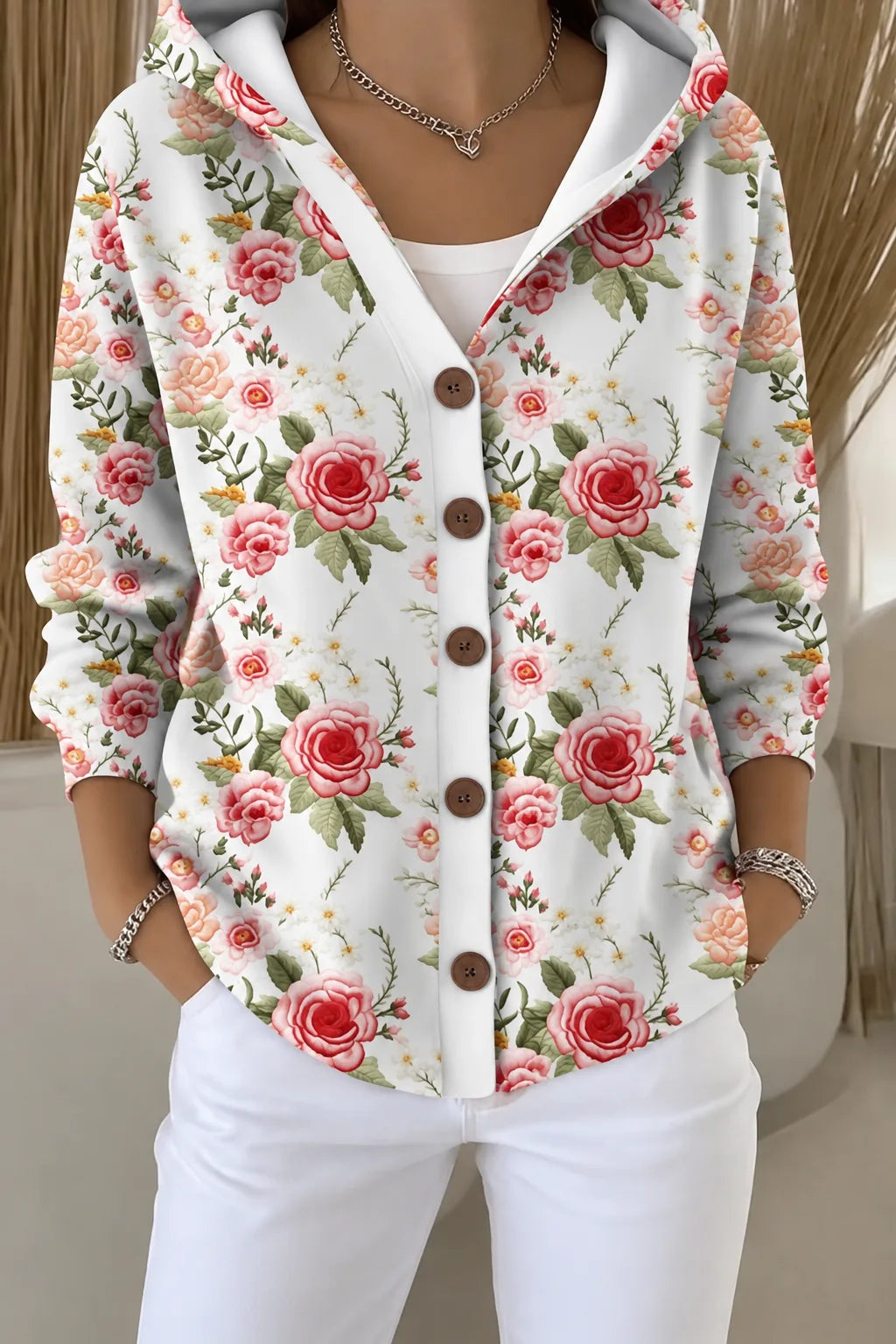 White hooded jacket with a romantic all-over pink and red rose floral print, fastened with brown buttons