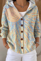 Pale yellow hooded jacket with a fine multicolour dotted pattern and a circular sunburst motif on the shoulder