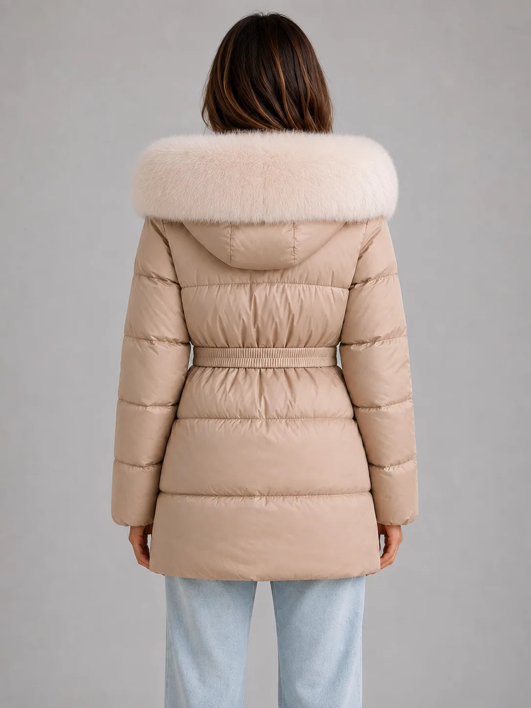 Back view of the beige quilted puffer jacket showing the cream faux fur hood trim and elasticated belt across the waistline