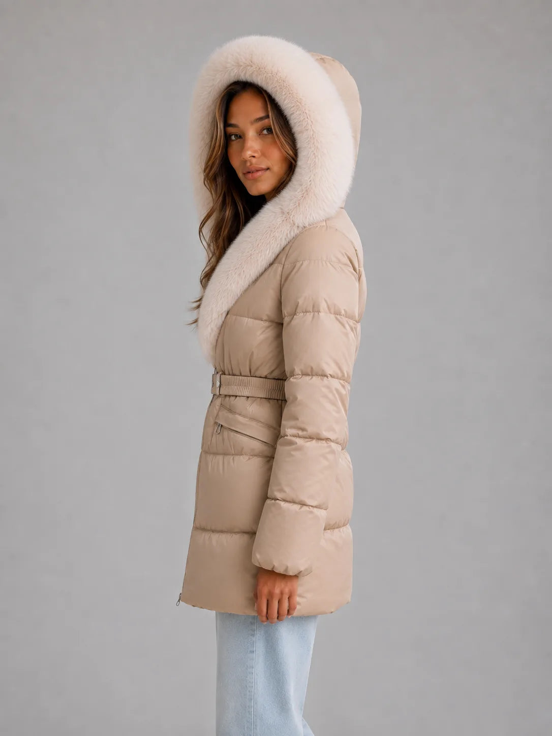 Side profile with the hood up, showing the deep cream faux fur trim framing the face and the quilted sleeve