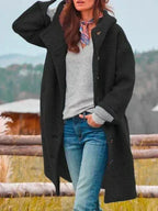 Black hooded wool coat with button fastening, worn with a printed neck scarf and denim