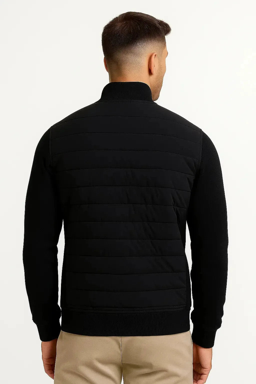 Back view of the black quilted jacket showing the knitted sleeves and horizontal quilted panelling across the shoulders