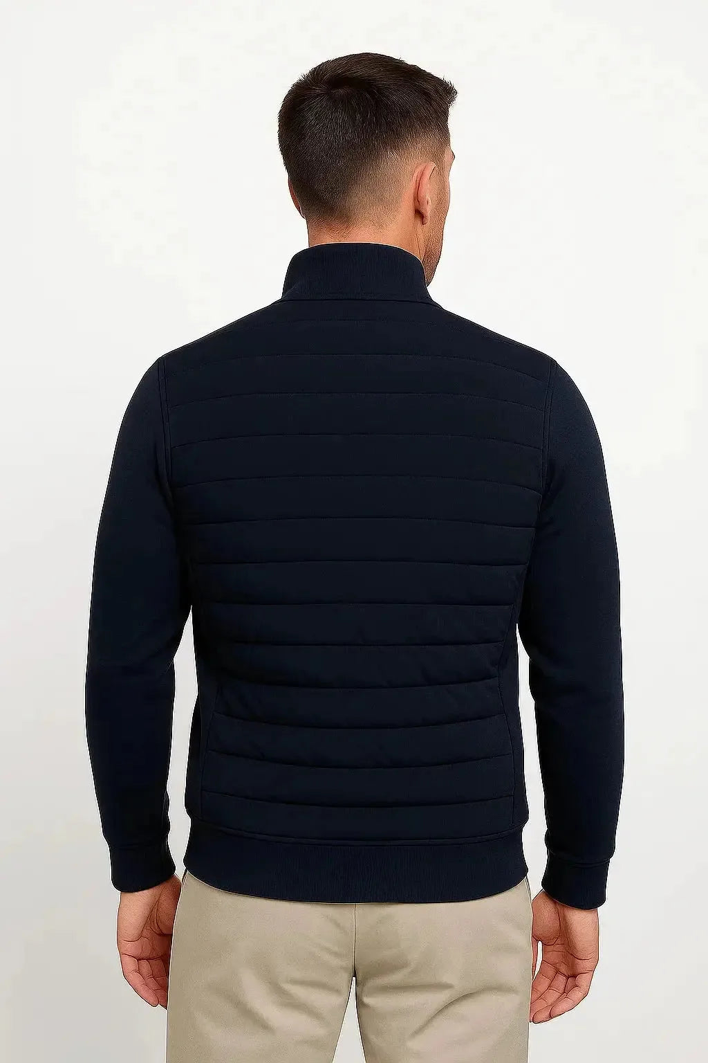Back view of the navy jacket showing the quilted panel construction and ribbed knit sleeves