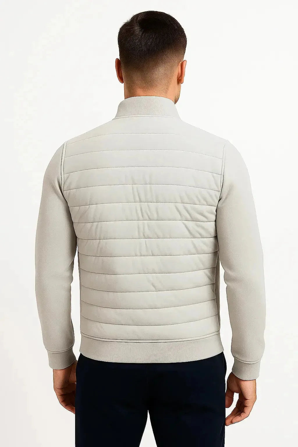 Back view of the light grey jacket highlighting the quilted back panel and knitted sleeve detail