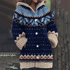 Navy blue knit hooded cardigan with light blue and mustard Fair Isle snowflake pattern across the yoke