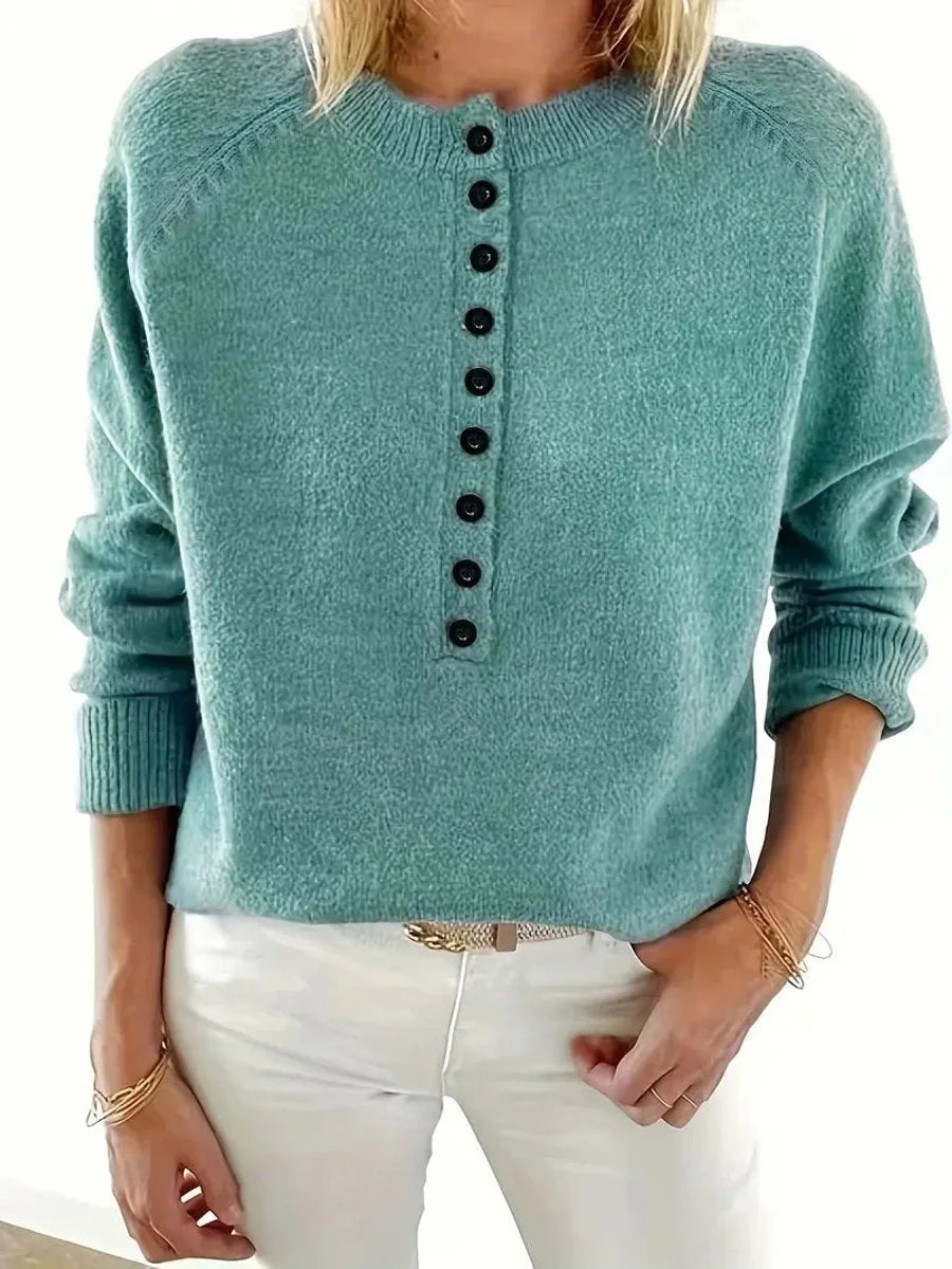Front view of an emerald green knit jumper showing the raglan sleeve seams and button-front neckline
