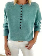 Front view of an emerald green knit jumper showing the raglan sleeve seams and button-front neckline