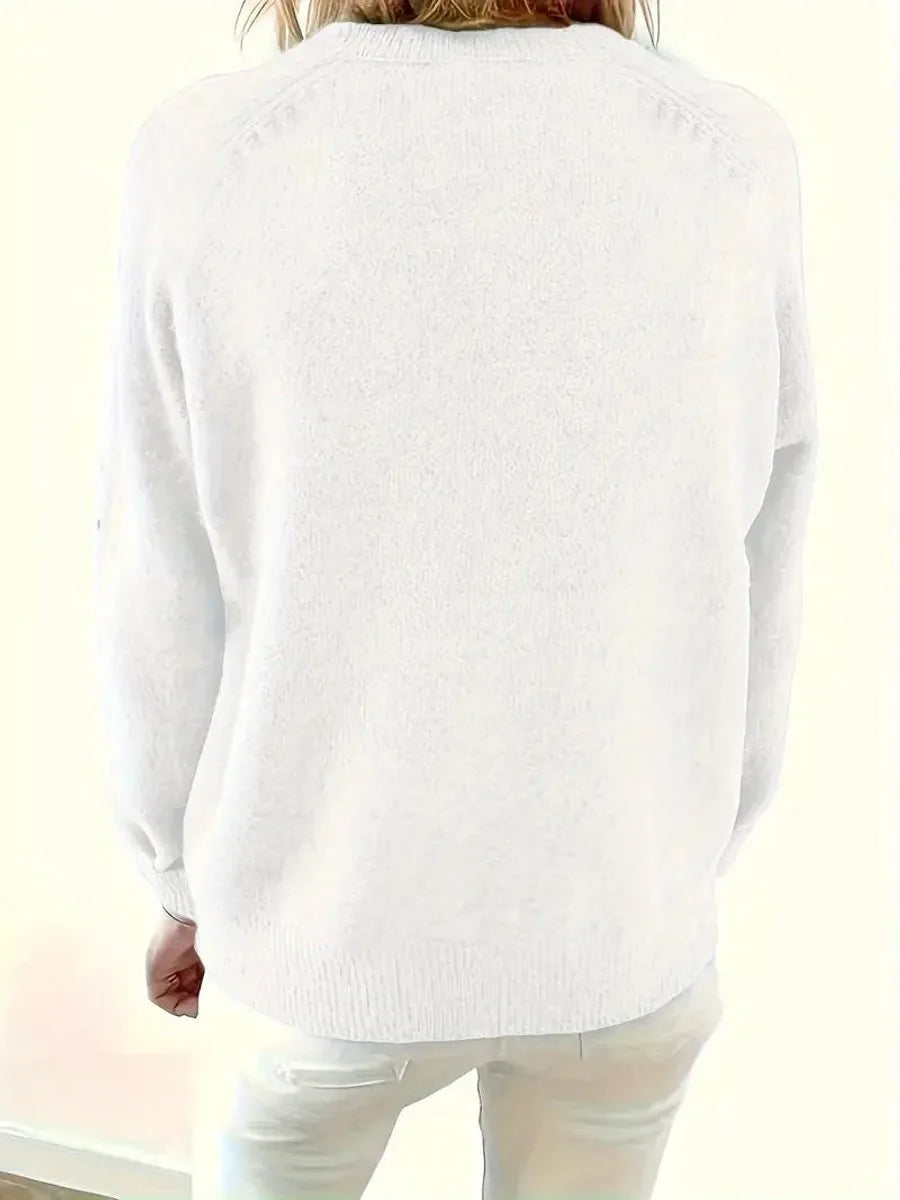 Side angle of a green knit jumper highlighting the soft brushed knit texture and button detail