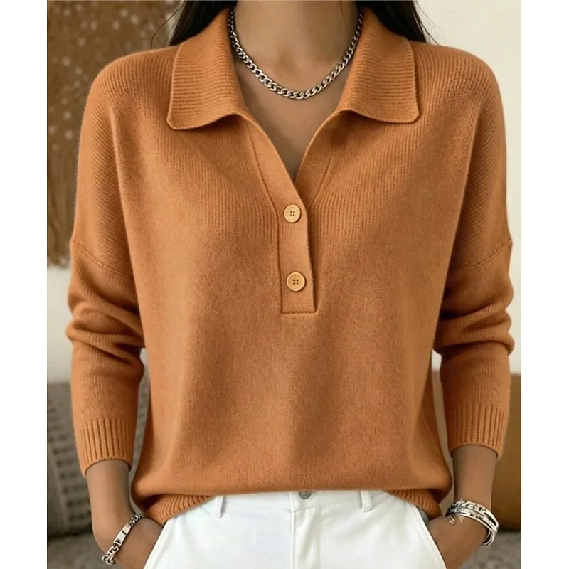 Light brown knitted collared jumper with wooden-tone buttons and ribbed hem, worn with white denim trousers.