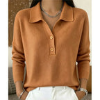 Light brown knitted collared jumper with wooden-tone buttons and ribbed hem, worn with white denim trousers.