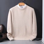 Beige knitted jumper with mock shirt collar detail, hanging beside brown leather shoes on a grey surface