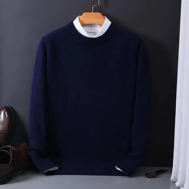 Navy knitted jumper with white layered collar and ribbed hem, hanging on a copper coat hanger