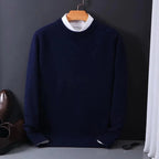 Navy knitted jumper with white layered collar and ribbed hem, hanging on a copper coat hanger